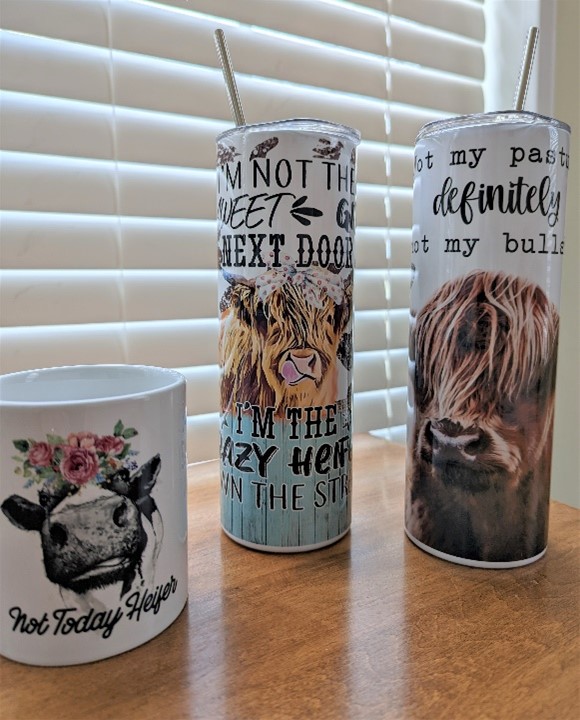 Variety of cup sizes with pictures of Highlands and silly sayings